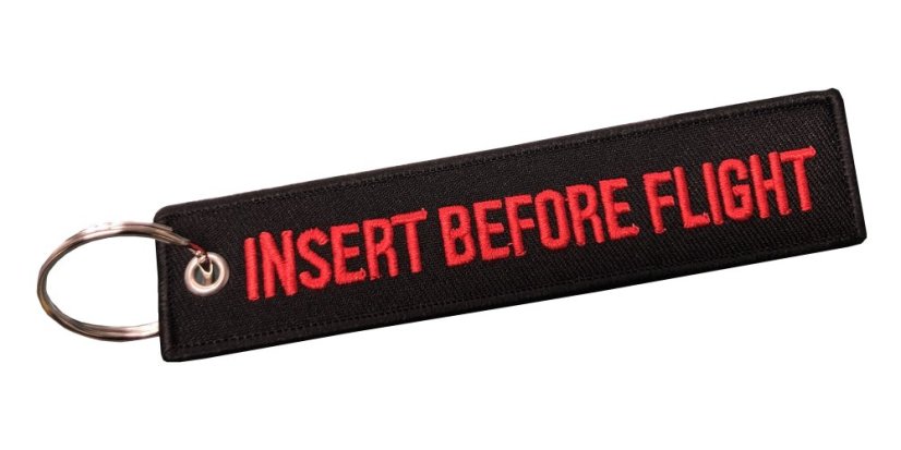 Přívěsek na klíče "Insert before flight"